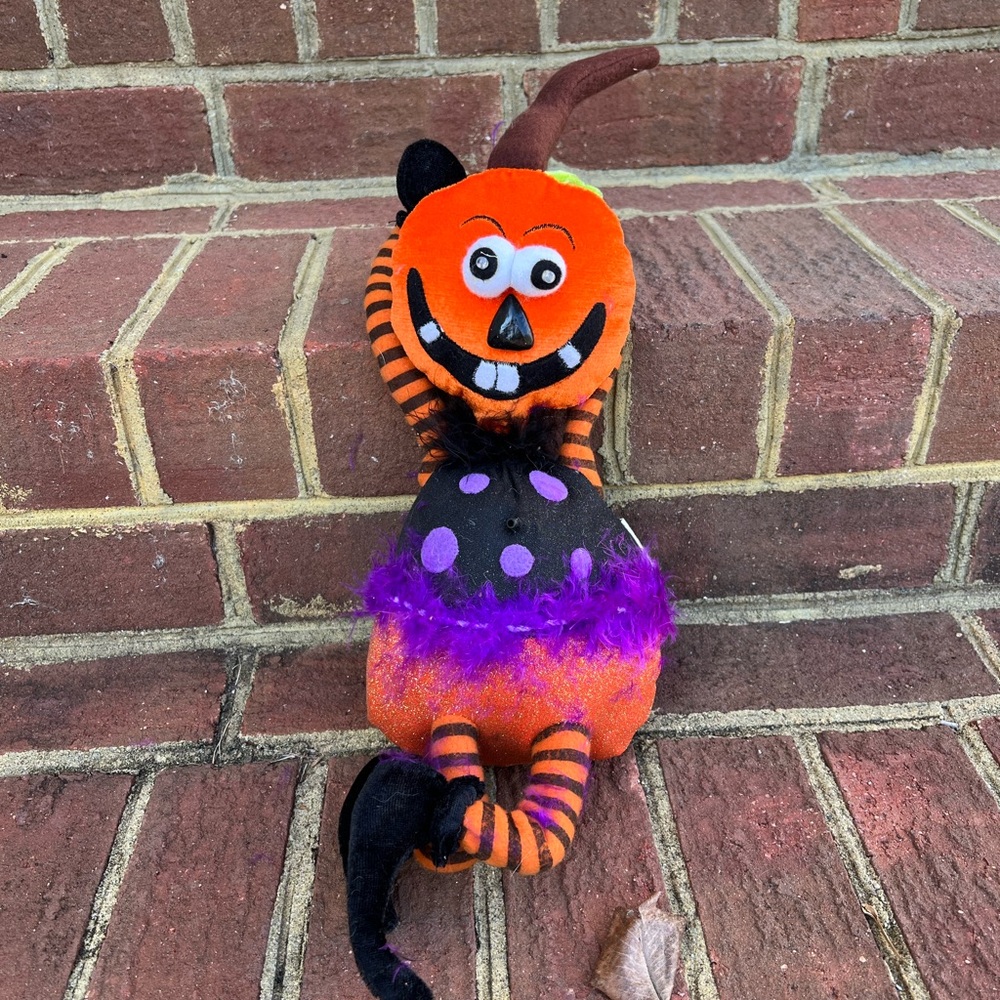 Orange and Black Plush Toy with Purple Accents